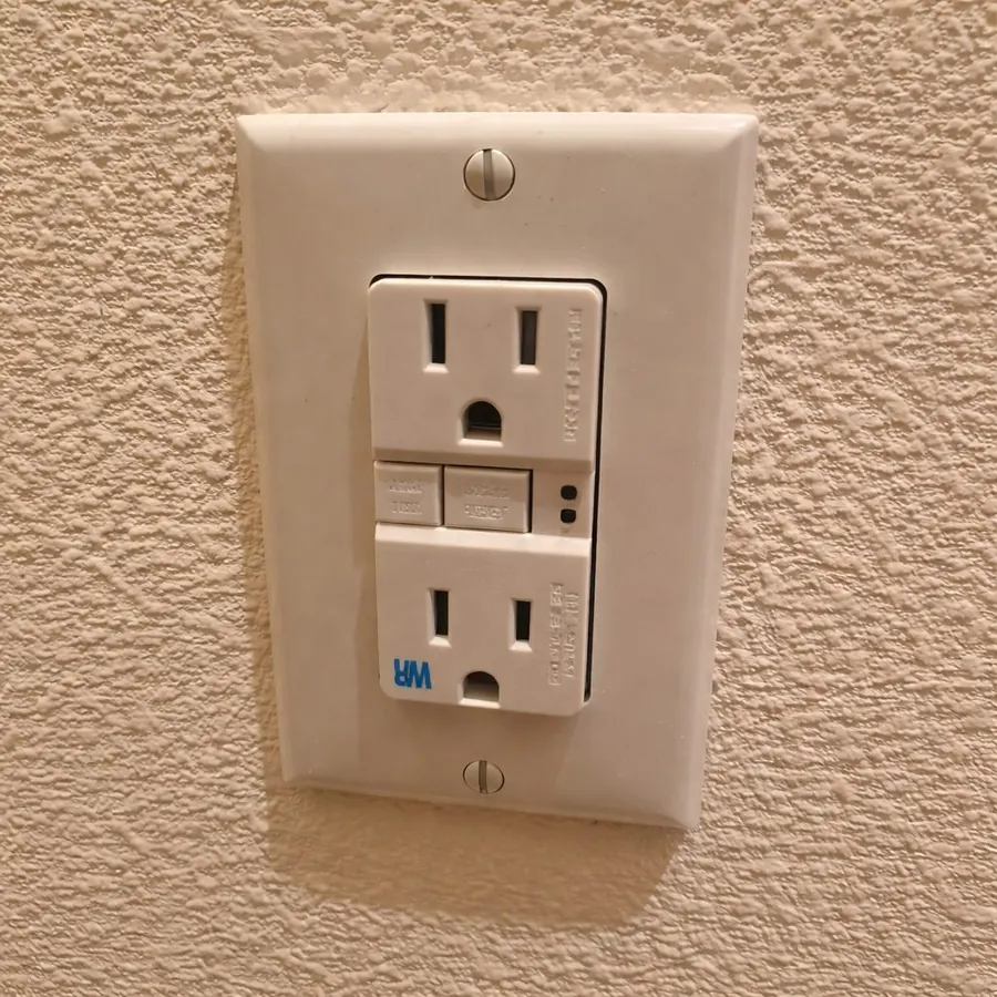 GFCI outlet on a textured wall