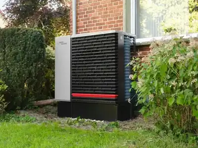 Outdoor heat pump unit beside a house