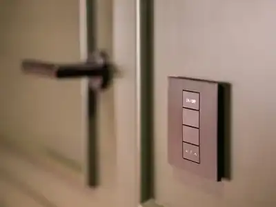 Smart switch panel on a wall beside a door