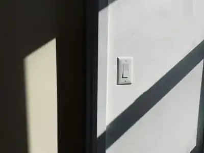 Light switch on a wall beside a door